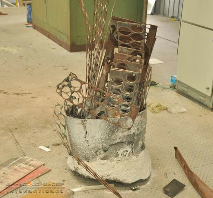 Photograph 3: View of the metal former containing melted and non-melted metal charge.